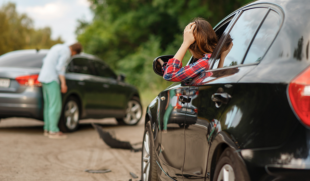 distraught woman after colliding with another car
